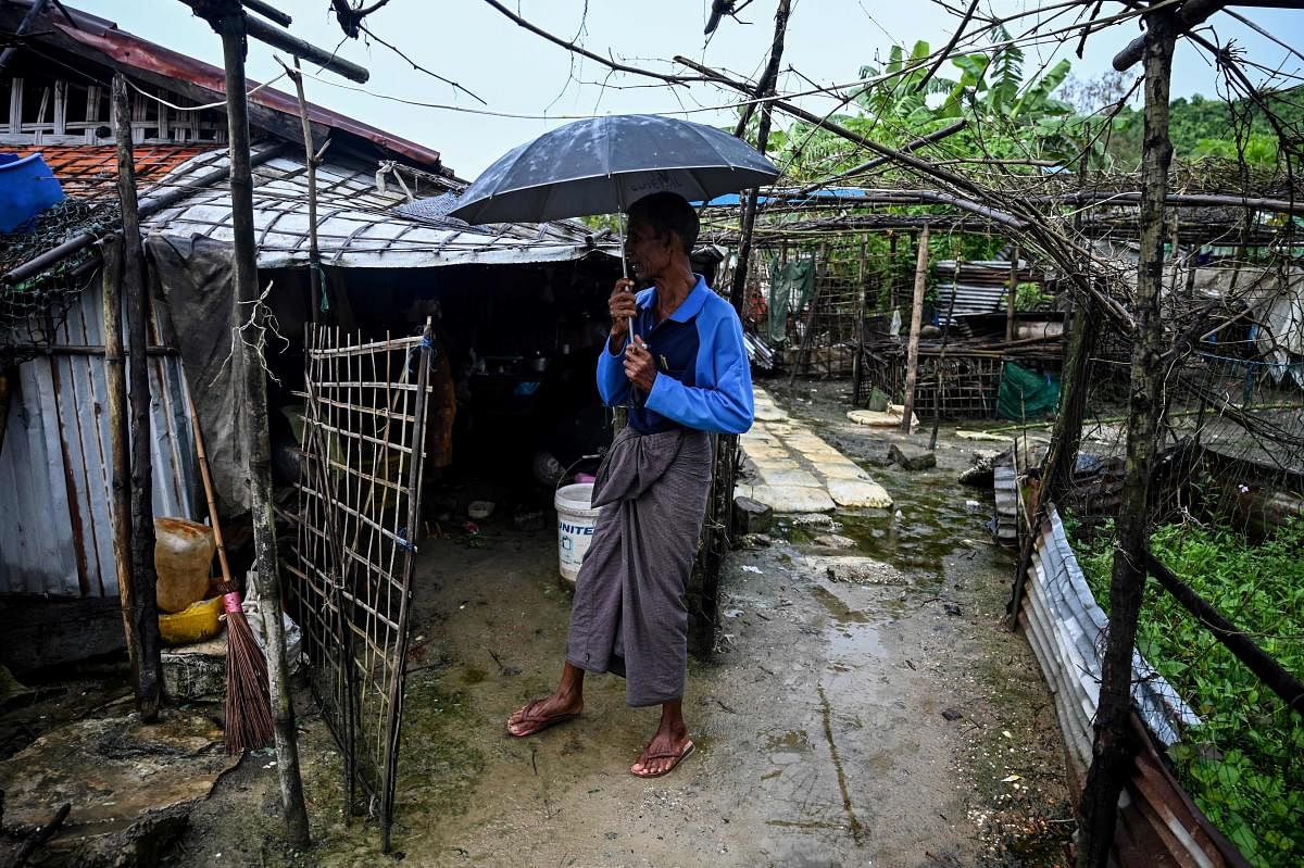 A man standing outside a house in Kyauktalone camp in Kyaukphyu, Rakhine (AFP photo)