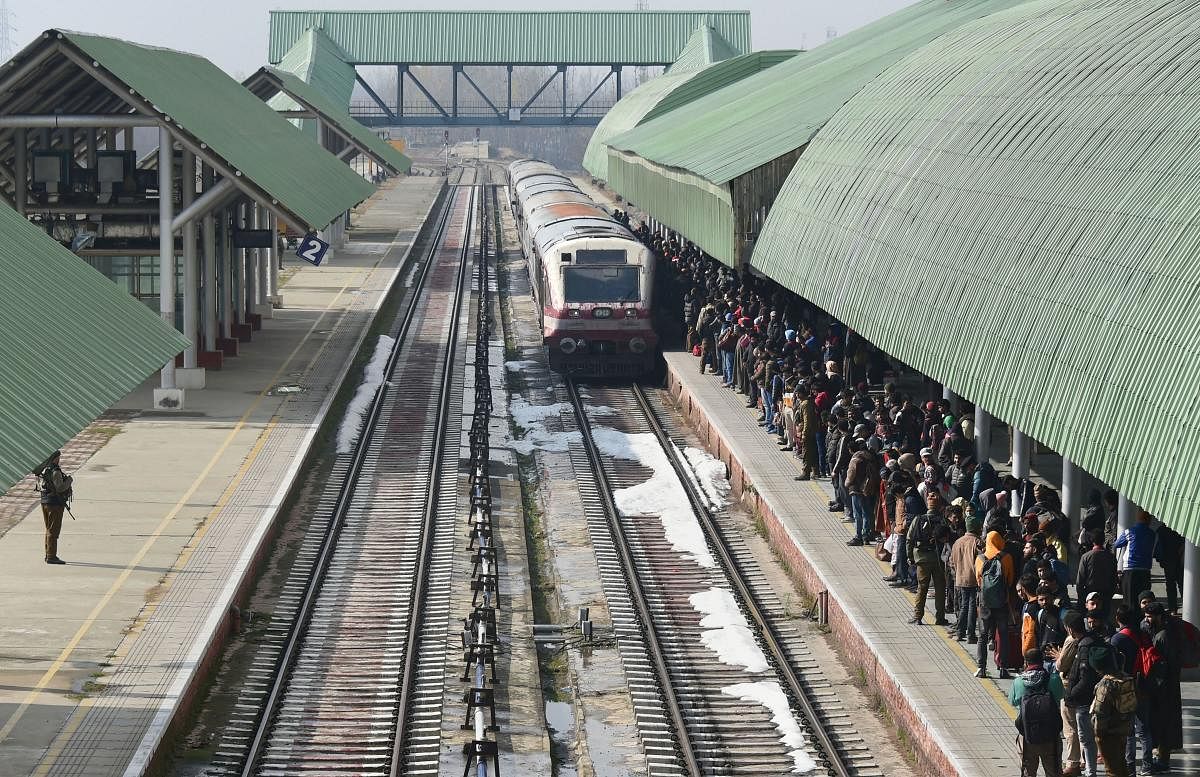Passengers wait as Baramulla-Srinagar-Banihal bound train arrives at a station in Srinagar, Sunday, Nov. 17, 2019. The rail service in Kashmir valley was fully resumed after it was suspended on 3rd August ahead of centre decision of abrogation of article