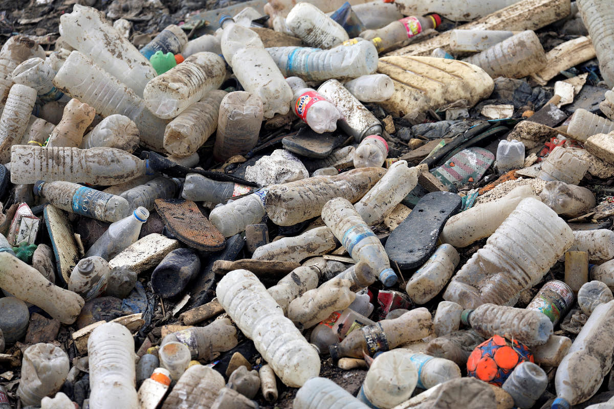 Plastic bottles and other waste are seen in a drain. (Photo by REUTERS)