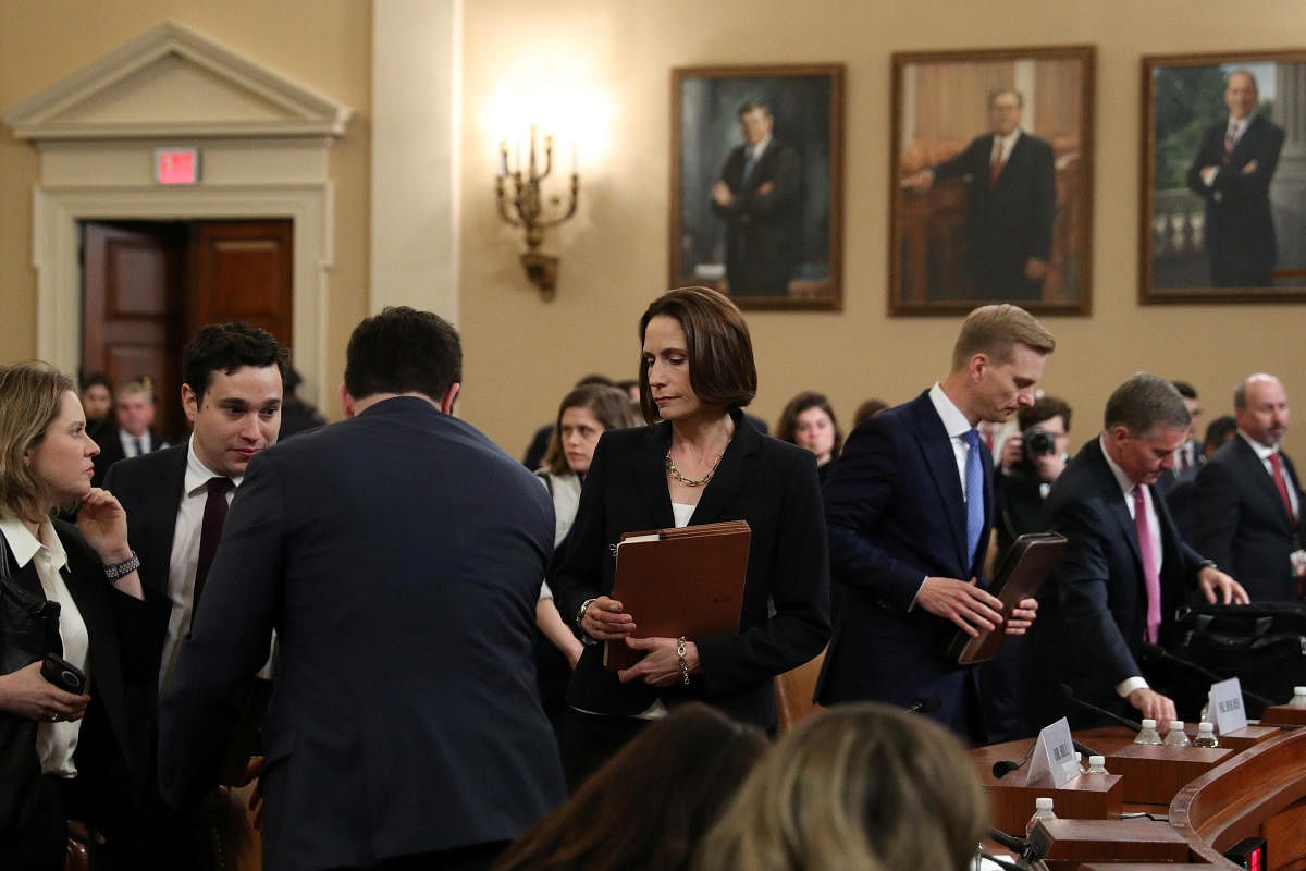 Fiona Hill, former senior director for Europe and Russia on the National Security Council, and David Holmes, political counselor at the U.S Embassy in Kiev, depart after testifying at a House Intelligence Committee hearing as part of the impeachment inqui