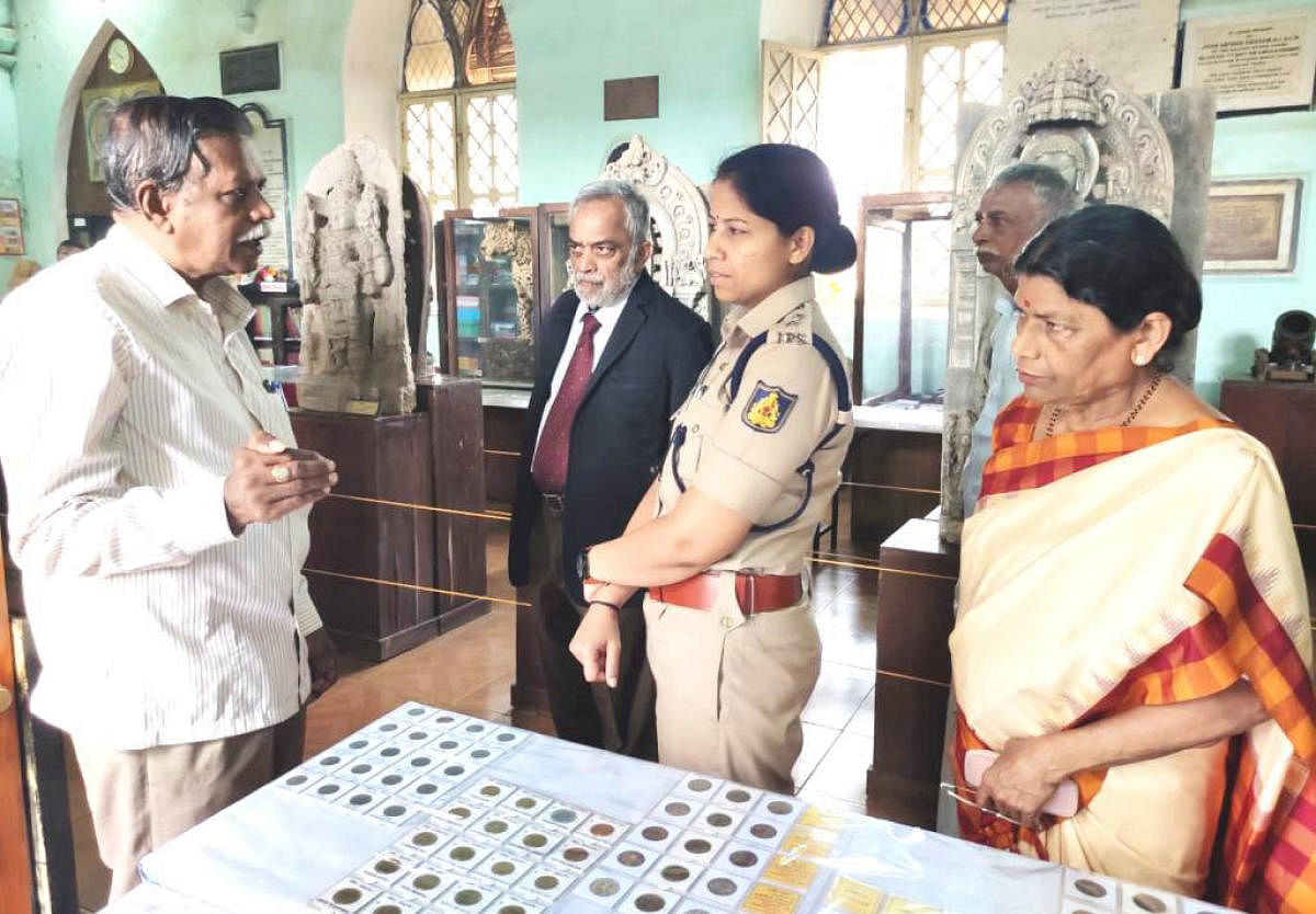 Superintendent of Police Dr Suman D Pennekar at the exhibition of coins and currency notes at Old Fort in Madikeri on Friday.