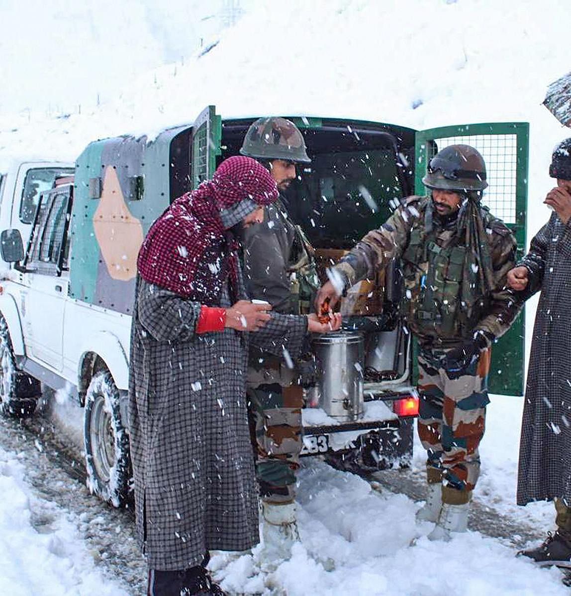 Army personnel during the rescue operation of civilians stranded due to heavy snowfall near Zojila Pass in J&amp;K, on Friday. Approximately 300-350 people, including women and children, were stranded at heights above 11,000 feet and temperatures of minus