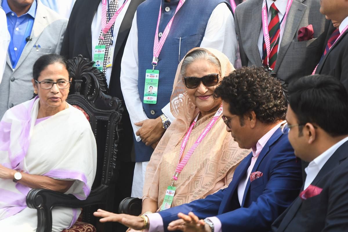 Bangladesh's Prime Minister Sheikh Hasina is accompanied by West Bengal Chief Minister Mamata Banerjee rings the opening bell for the first day of the second Test cricket match of a two-match series between India and Bangladesh at The Eden Gardens cricket stadium in Kolkata on November 22, 2019. Photo/AFP