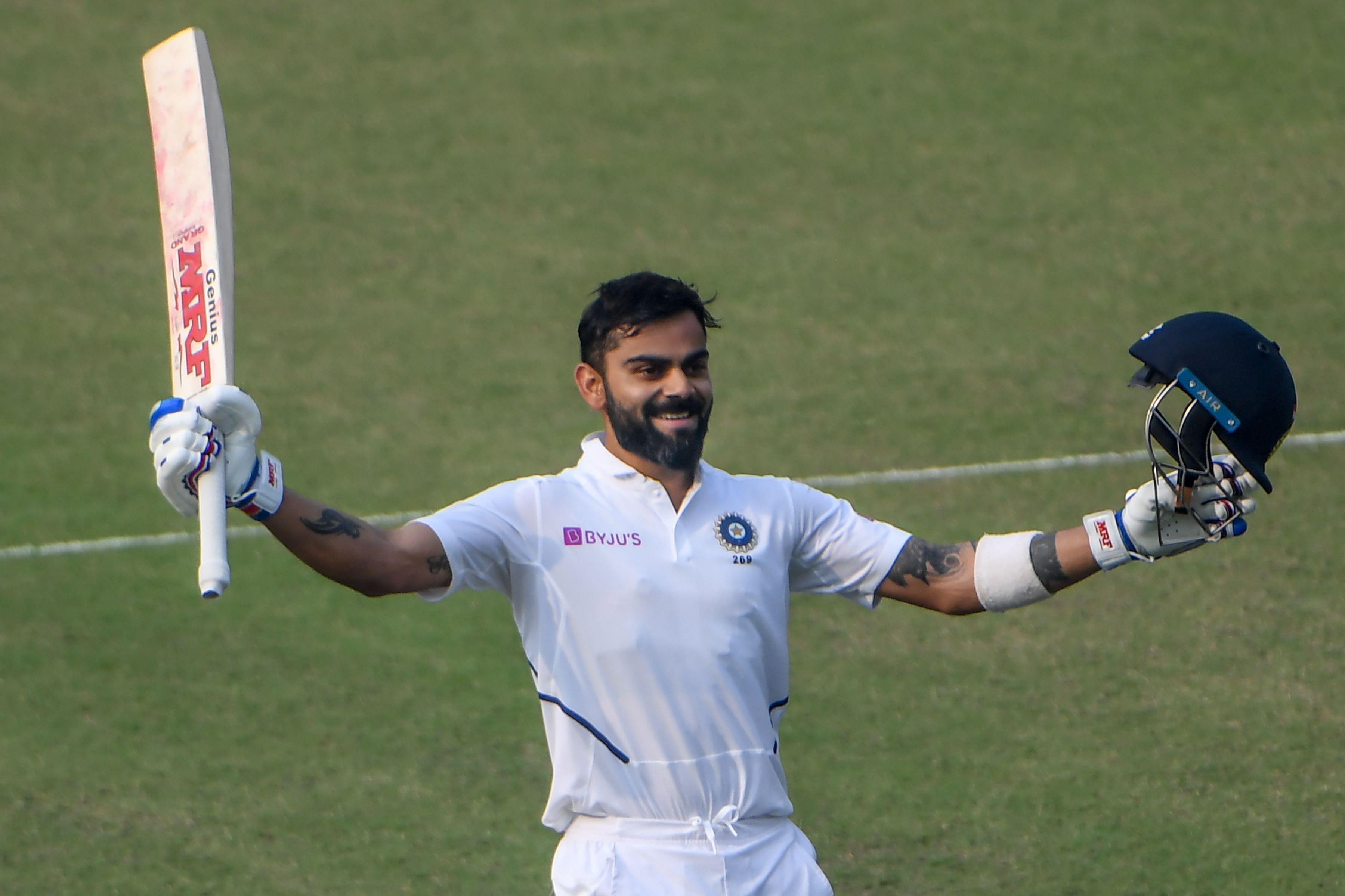 India's captain Virat Kohli celebrates his century (100 runs) during the second day of the second Test cricket match of a two-match series between India and Bangladesh at the Eden Gardens cricket stadium in Kolkata. (AFP Photo) 