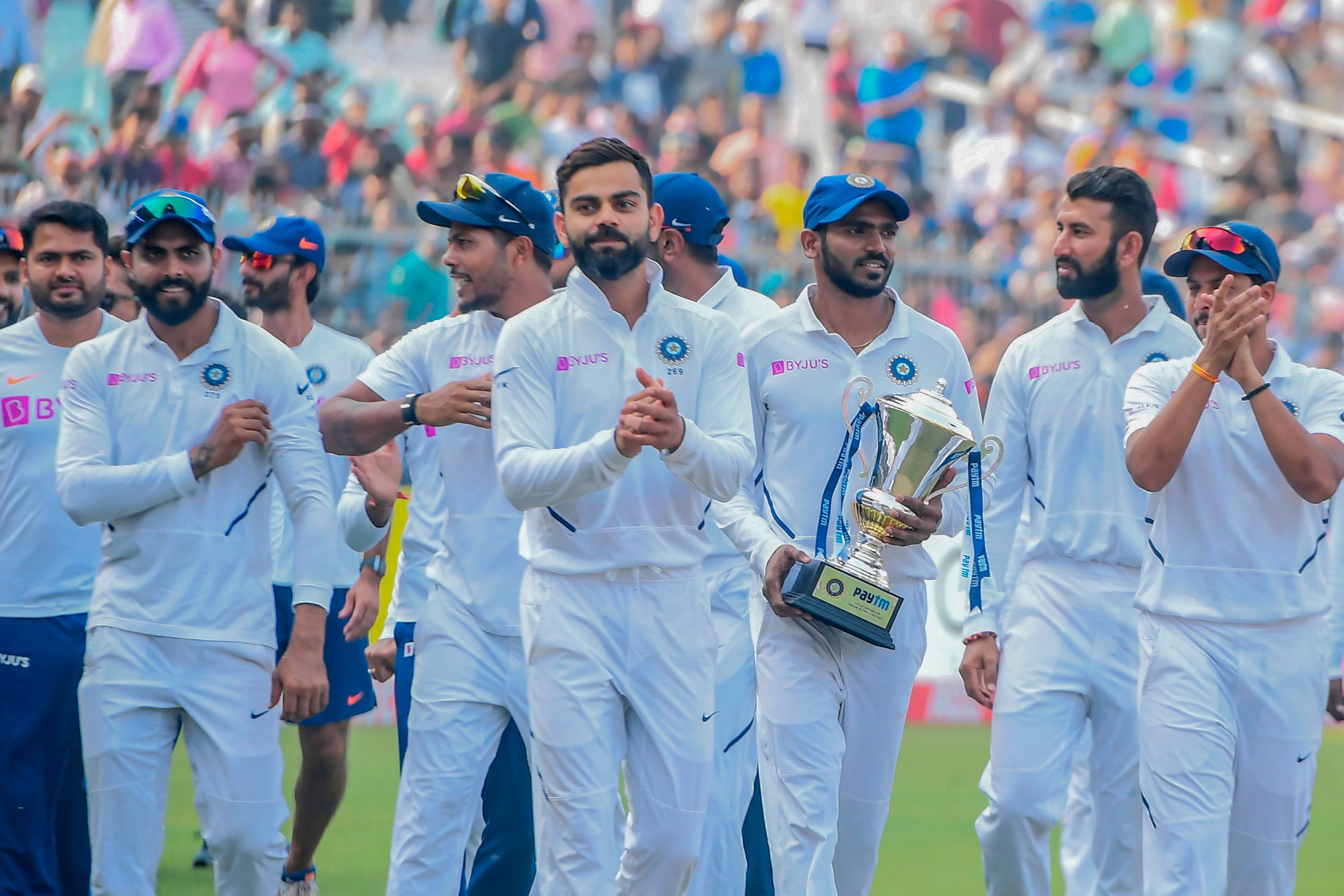 India's cricketers celebrate after winning the match during the third day of the second Test cricket match of a two-match series between India and Bangladesh at the Eden Gardens cricket stadium in Kolkata. (AFP Photo)