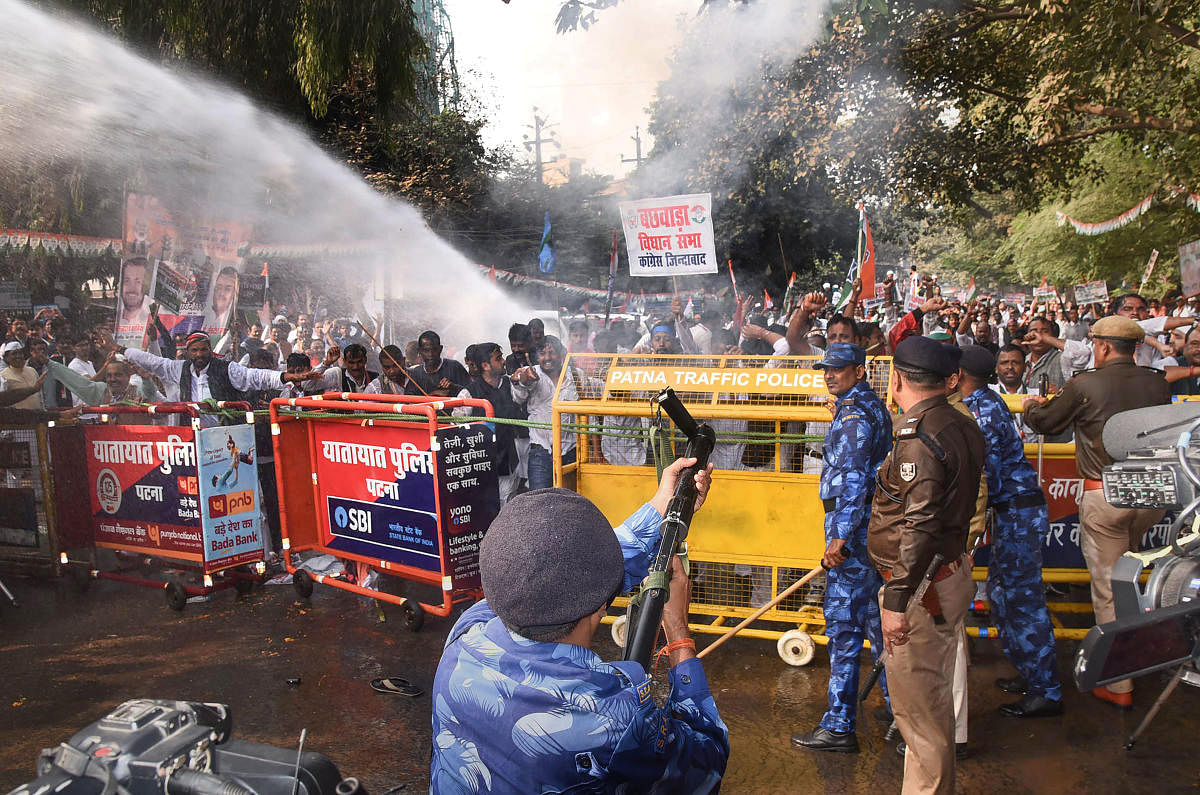 Security personnel fire tear gas to disperse Congress workers during Jan Vedna March, in Patna, Sunday, Nov. 24, 2019. (PTI Photo)