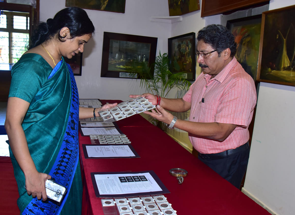 Numismatist Krishna Prasad Rai explains about his collection to Deputy Commissioner Sindhu B Rupesh at the exhibition of coins held at Srimanthi Bai Memorial Government Museum in Bejai. 