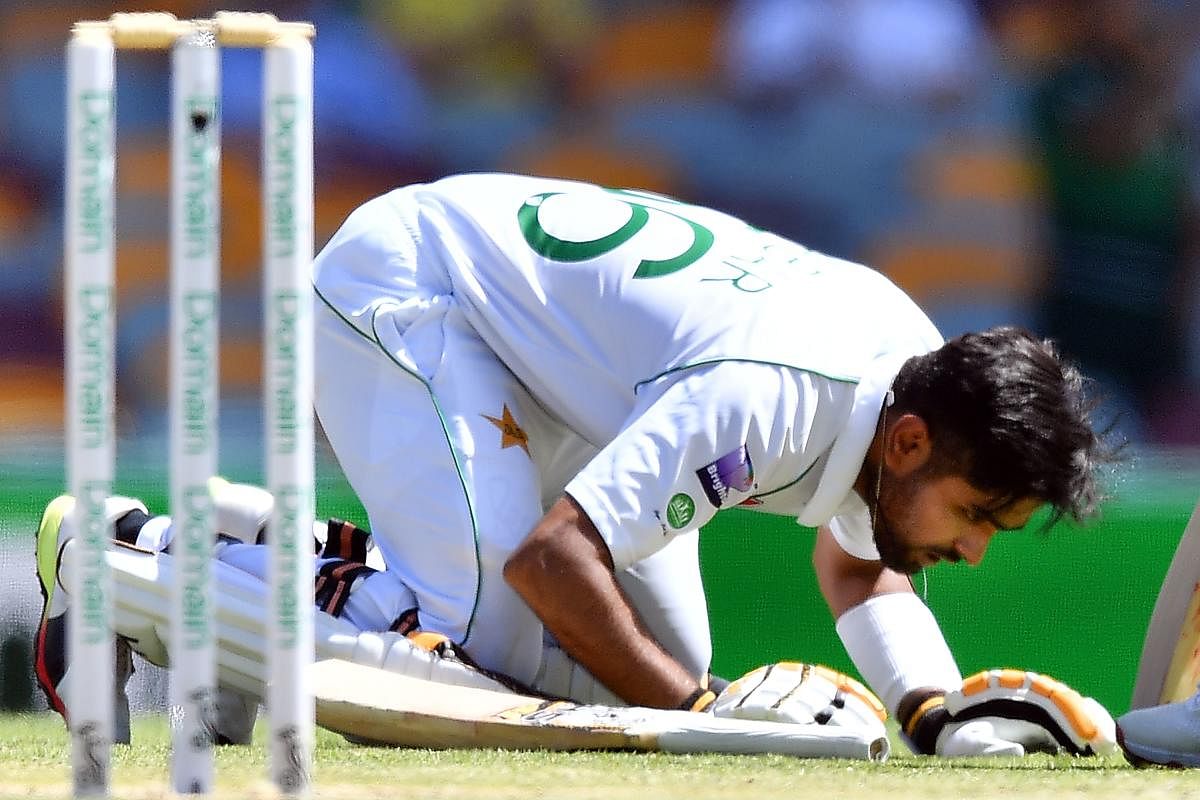 Pakistan's batsman Babar Azam celebrates reaching his century, 100 runs, on day four of the first Test cricket match between Pakistan and Australia at the Gabba in Brisbane.