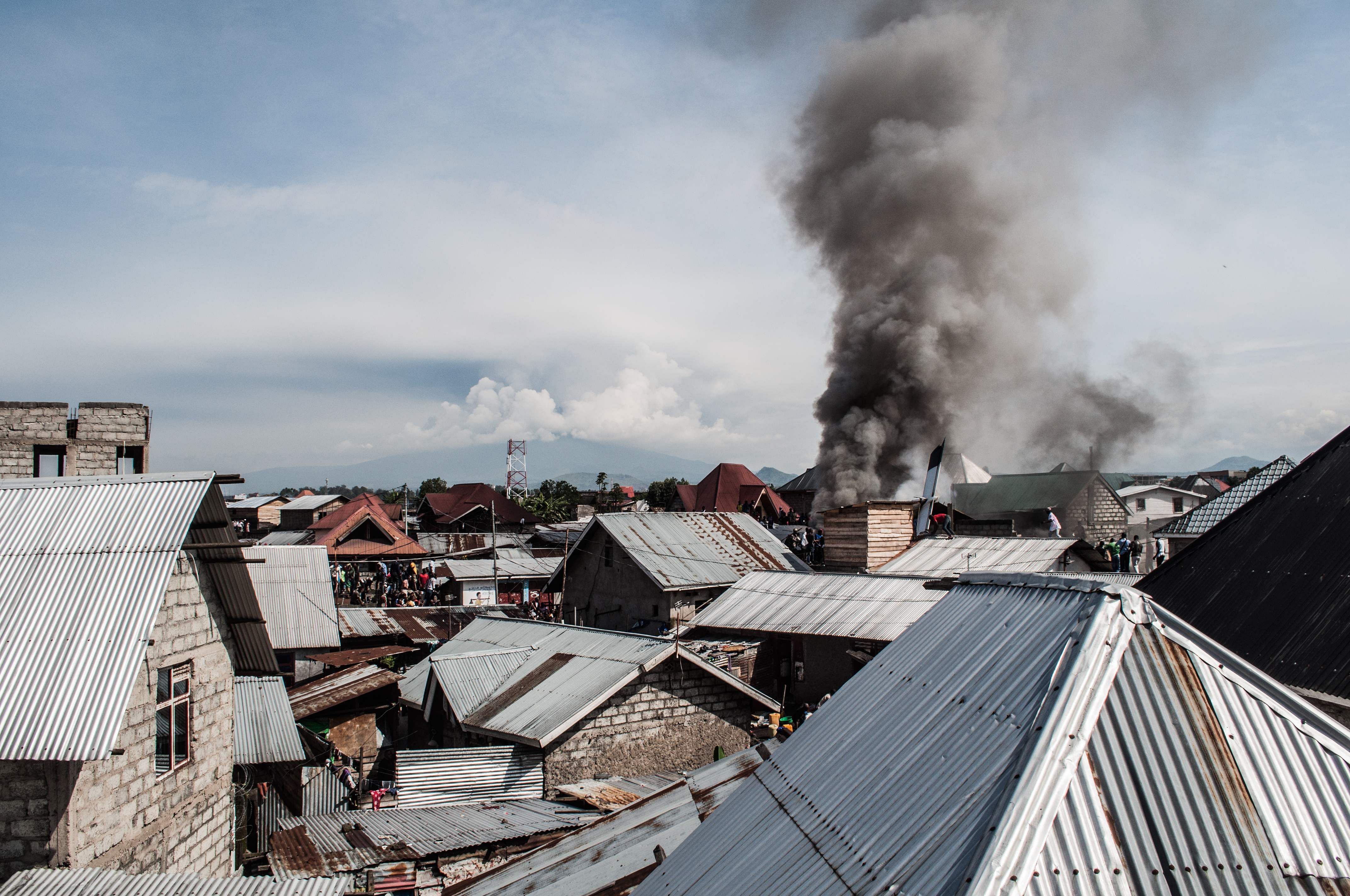 Smoke raises after a small aircraft carrying around 15 passengers crashed in a densely populated area in Goma on the East of the Democratic Republic of Congo. (AFP Photo)