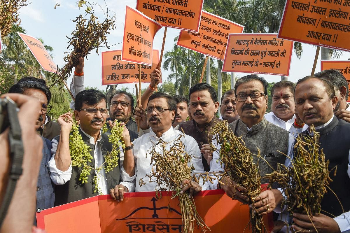 Shiv Sena leaders Sanjay Raut, Arvind Sawant, and others hold a protest near Chhatrapati Shivaji Maharaj statue, demanding the government to declare unseasonal rains in Maharashtra as natural calamity, on the first day of the Winter Session of Parliament.