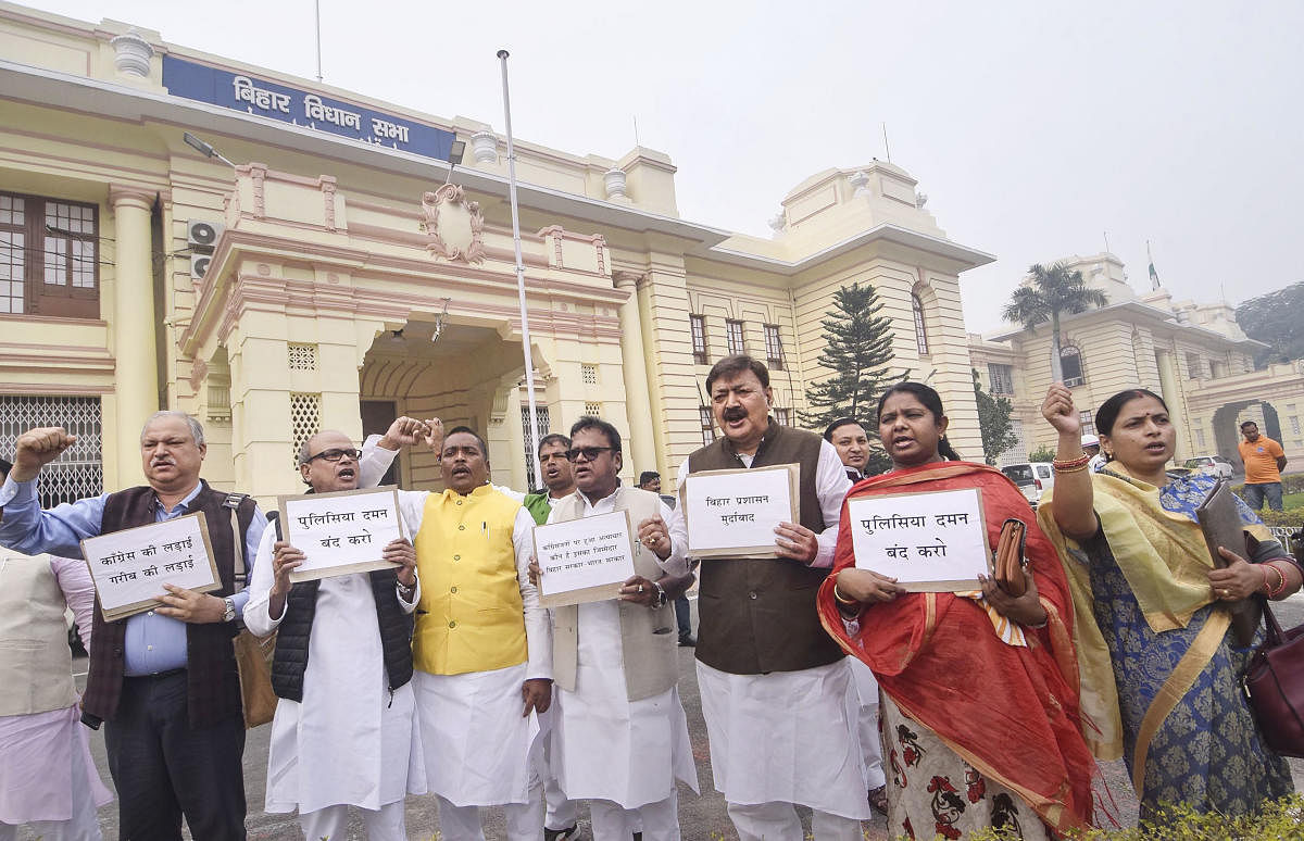 Congress legislators stage a protest during Winter Session of the Assembly, in Patna. (PTI Photo)