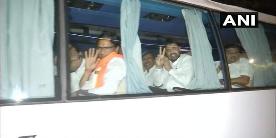 The MLAs travelled in a bus to a different hotel from Hotel Renaissance in Powai where they were put up since Saturday night, hours after NCP leader Ajit Pawar joined hands with the BJP in a coup and took oath as deputy chief minister. Photo/ANI