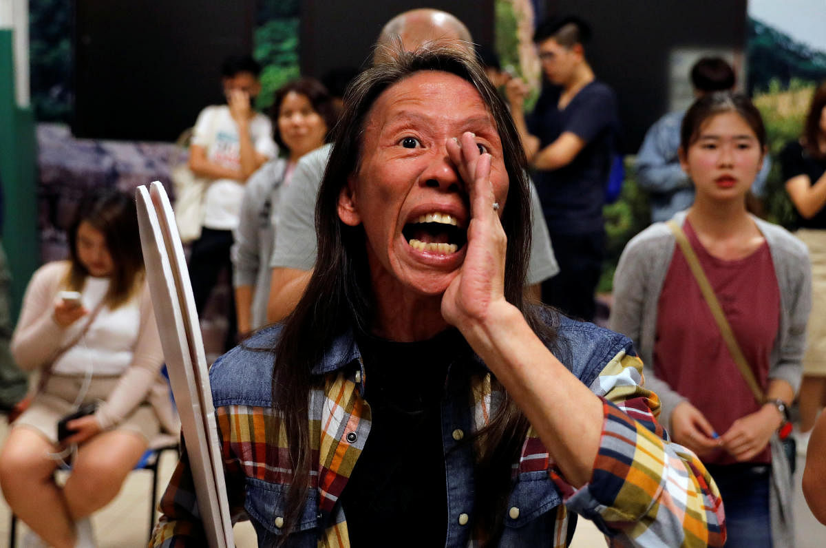 A woman reacts during the counting of the votes of the Hong Kong council elections, in a polling station in Hong Kong