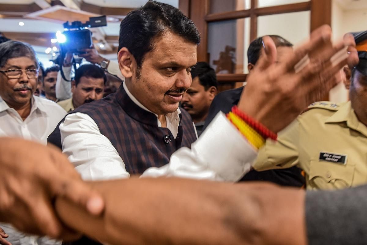 Bharatiya Janata Party (BJP) leader and Chief Minister of the western Indian state of Maharashtra Devendra Fadnavis (C) arrives for a press conference to announce his decision to tender his resignation in Mumbai on November 26, 2019. (AFP)