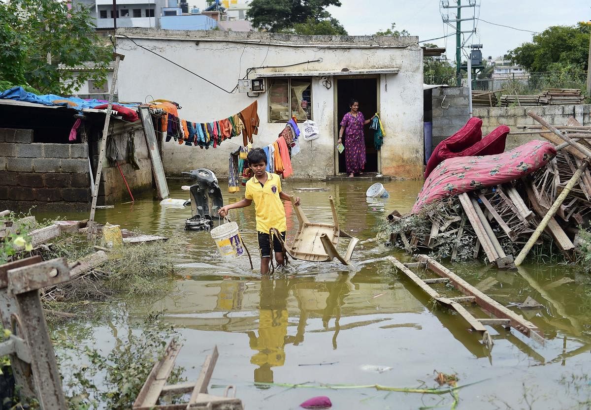 The Hulimavu Lake bund breached around 2.30 pm on Sunday, flooding homes, streets, vehicles and whatnot. Many residents reported losing expensive home appliances, furniture, electronic gadgets, etc. Several commercial establishments also reported losses. Photo/PTI