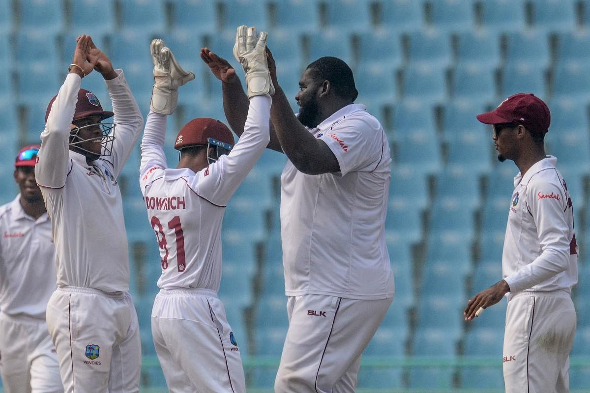 West Indies' cricketers celebrate during the international Test cricket match between Afghanistan and West Indies. (AFP Photo)