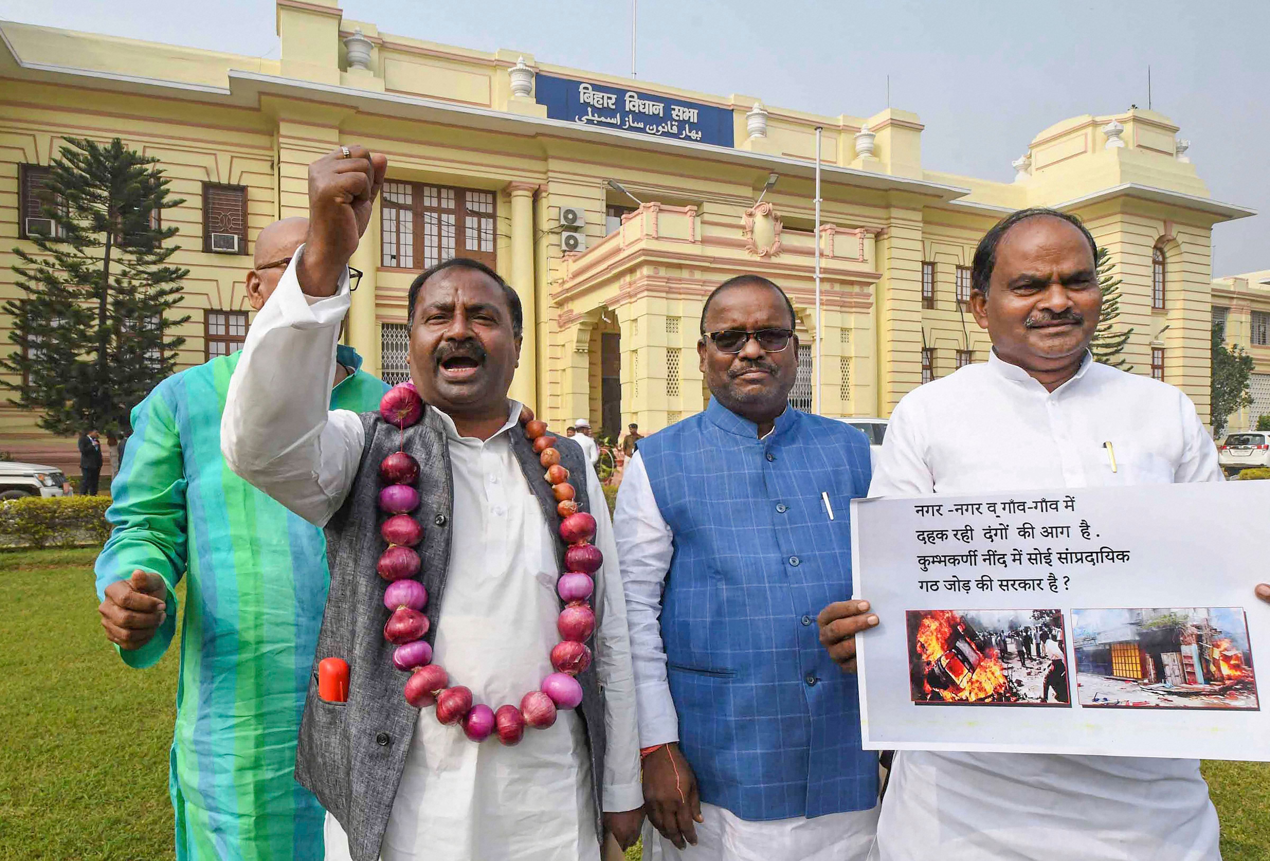 RJD MLA Shiv Chandra Ram raise slogans during a demonstration against the government for failing to control soaring prices of onions during the ongoing Winter Session of Bihar Assembly, in Patna. (PTI Photo)
