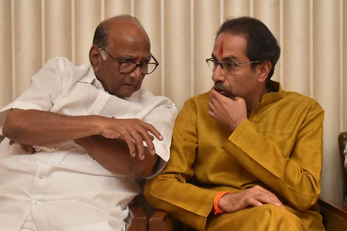 Shiv Sena Party leader Uddhav Thackeray (R) confers with Nationalist Congress Party (NCP) leader Sharad Pawar. (AFP file photo)