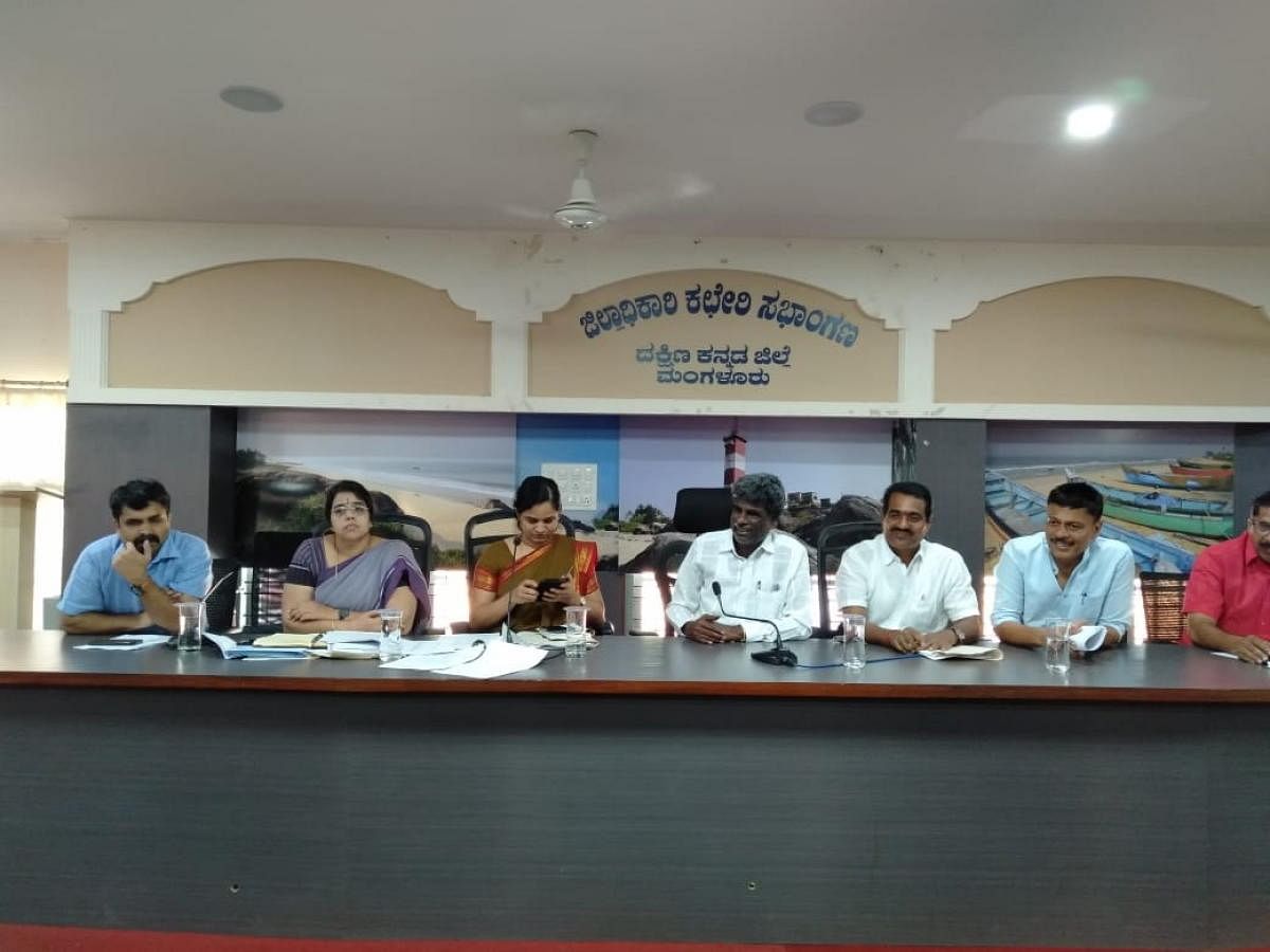 District In-charge Minister Kota Srinivas Poojari chairs a meeting at the deputy commissioner’s office in Mangaluru on Tuesday.