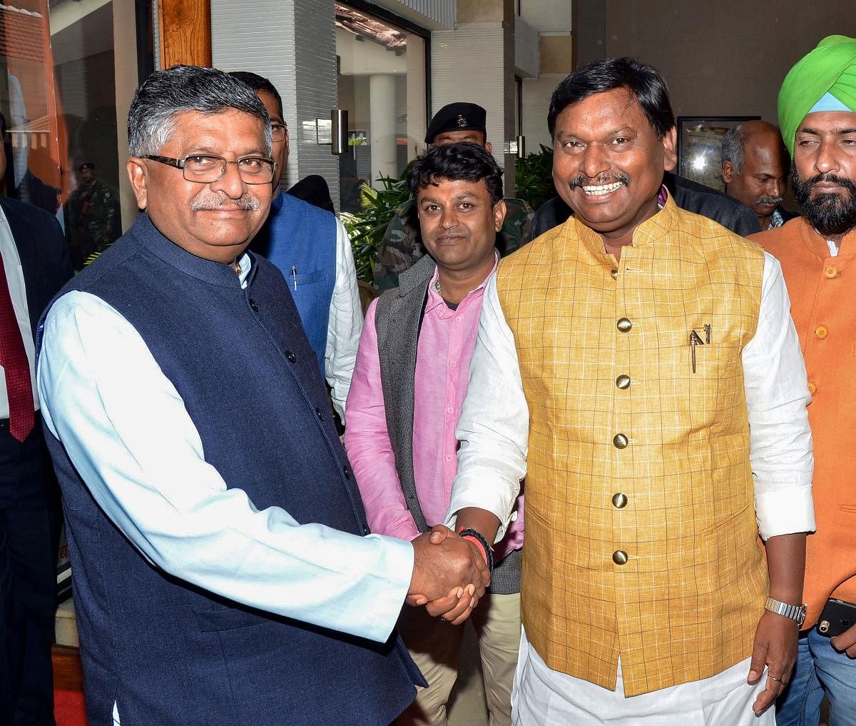 IT and Telecom Minister Ravi Shankar Prasad(L) shakes hands with Union Tribal Affairs Minister Arjun Munda during the release of BJP manifesto for Jharkhand Assembly Elections-2019, in Ranchi. (PTI Photo)