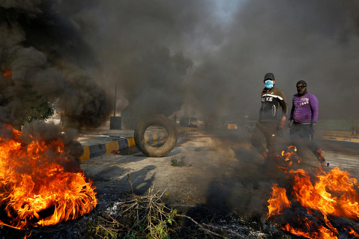 Iraqi anti-government protesters blocked roads in the country's south with burning tyres on Wednesday, as schools and public offices stayed shut a day after deadly clashes with security forces. Photo/REUTERS