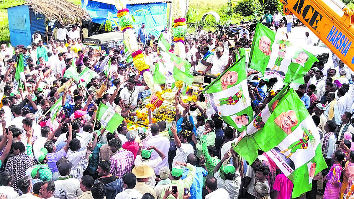 JD(S) workers accord a grand welcome to former chief minister H D Kumaraswamy and former minister H D Revanna at Santhebachahalli in KR Pet taluk, Mandya district, on Wednesday. dh photo