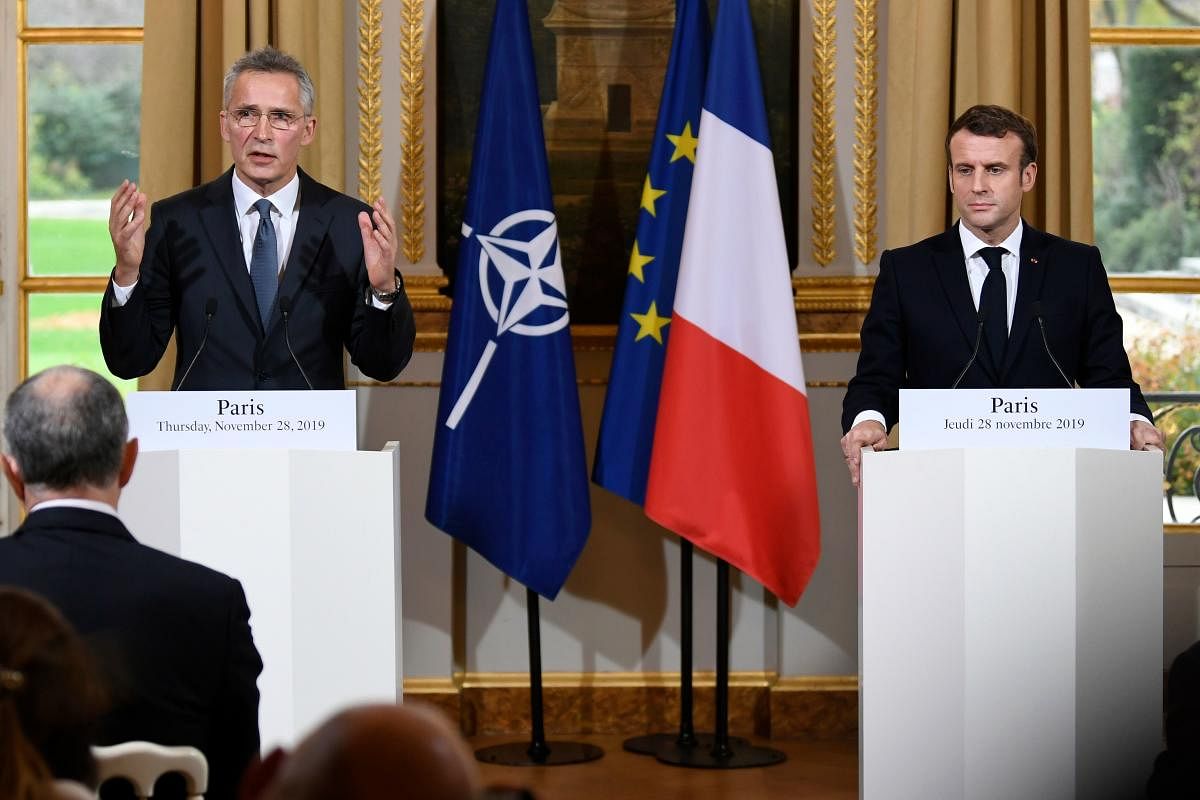 French President Emmanuel Macron and NATO Secretary-General Jens Stoltenberg give a press conference after a meeting at the Elusee palave in Paris. (AFP Photo)