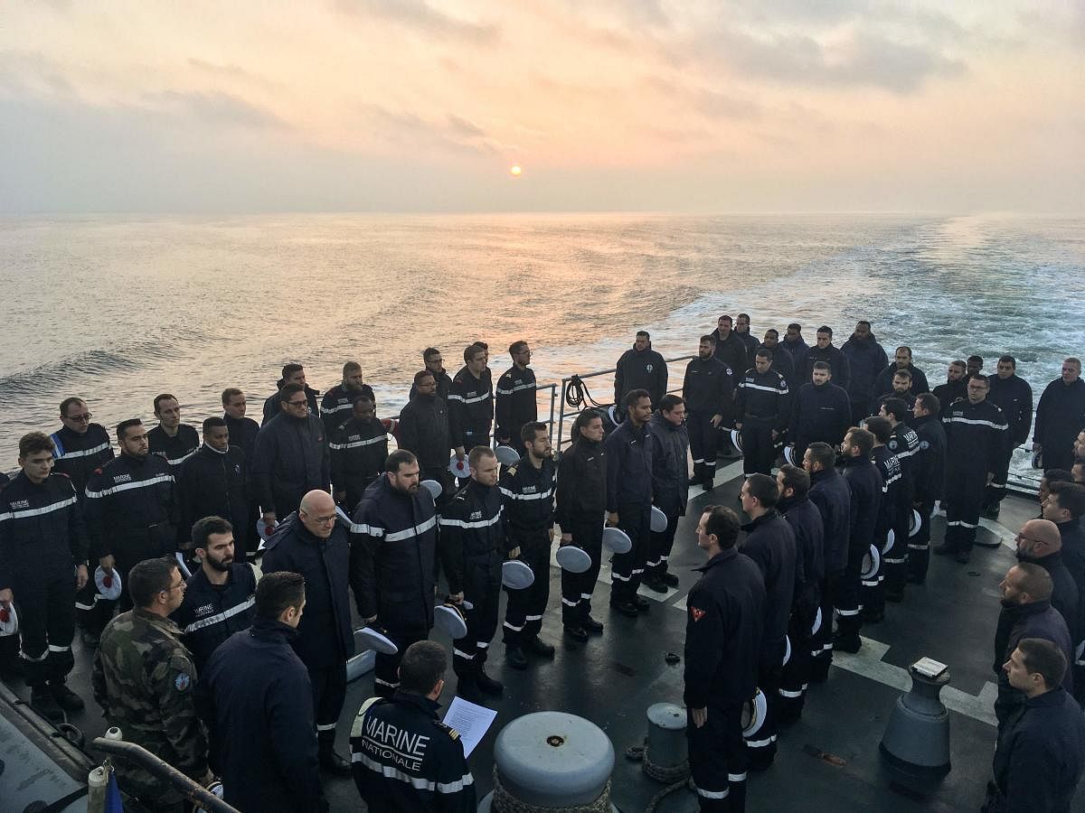French sailors stand during a minute of silence on board Marine Nationale ship Commandant Birot (Aviso Type - Classe d'Estienne d'Orves) at an undisclosed location in The Black Sea, early November 28, 2019, as they remember the thirteen French soldiers killed when two helicopters collided during Operation Barkhane in Mali. (AFP Photo)