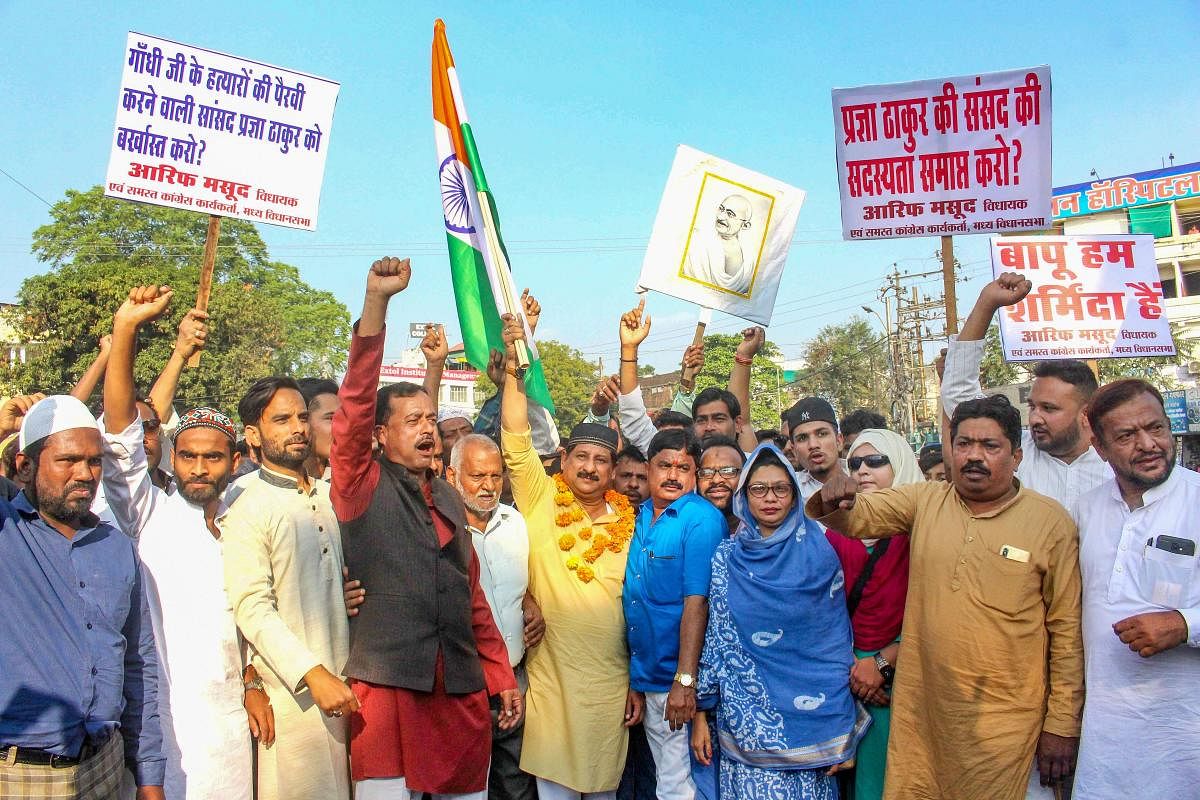 Congress MLA Arif Masood leads party supporters in a protest demanding suspension of BJP MP Sadhvi Pragya Singh Thakur for her remarks on Mahatma Gandhi's assassin Nathuram Godse.