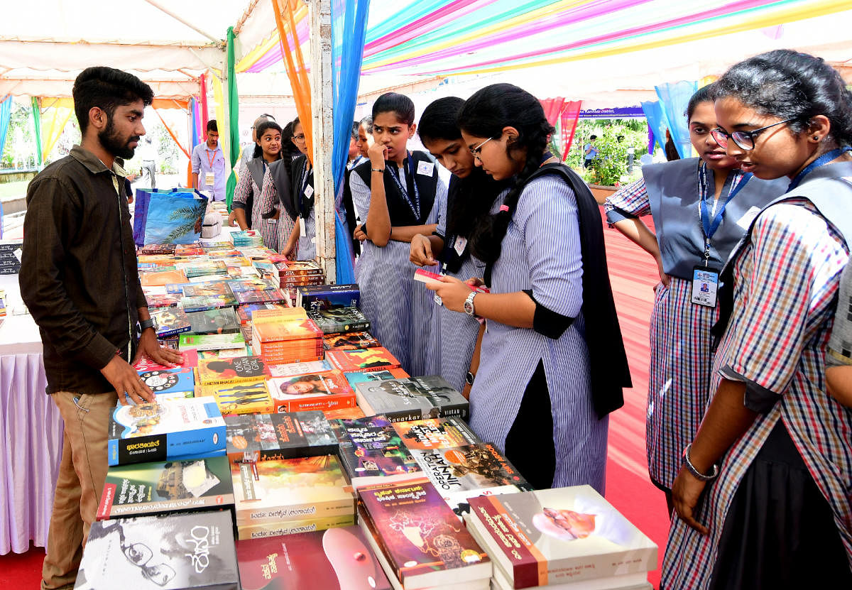 Students browse books at the book exhibition organised as part of Mangaluru Lit Fest 2019 at Dr T M A Pai International Convention Centre on Friday.