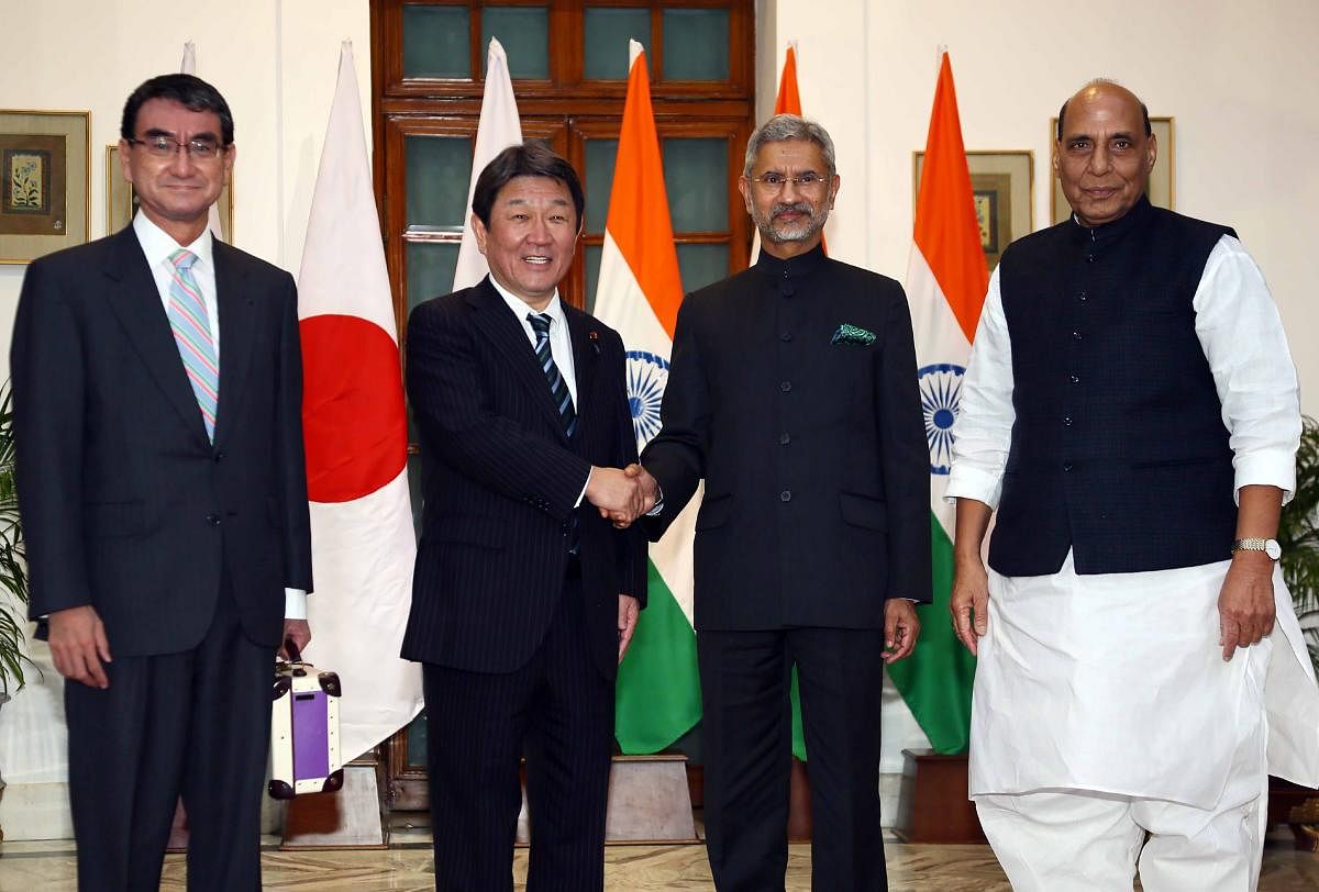 Japan's Foreign Minister Toshimitsu Motegi (2L) shakes hands with his Indian counterpart Subrahmanyam Jaishankar (2R) as India's Defence Minister Rajnath Singh (R) and Japan's Defence Minister Taro Kono (L) pose during their bilateral talks in New Delhi. (AFP Photo)