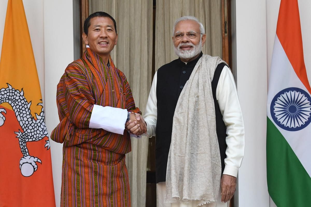 Indian Prime Minister Narendra Modi (R) shakes hands with Bhutan's Prime Minister Lotay Tshering. (AFP Photo)