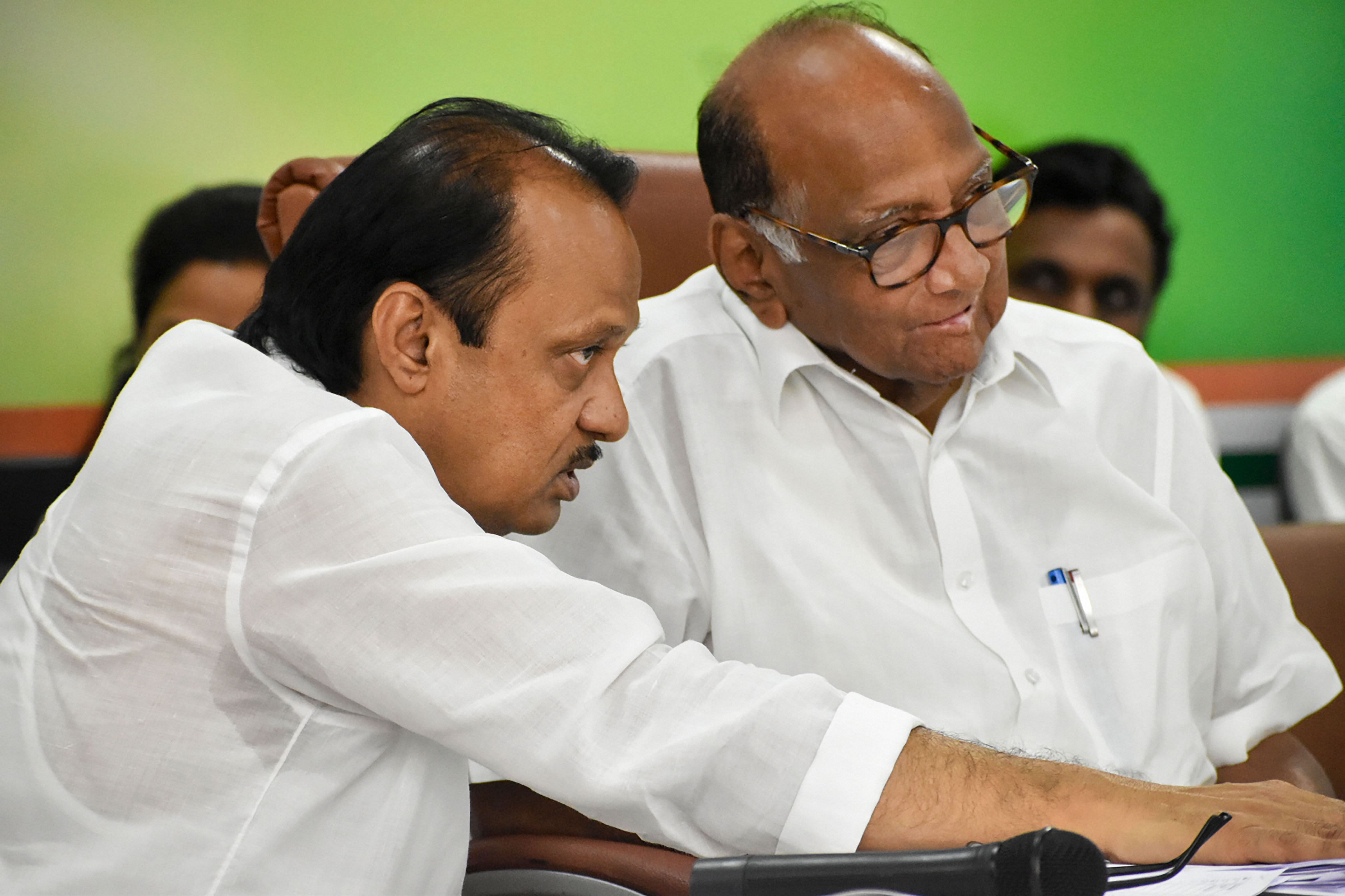 Nationalist Congress President (NCP) Sharad Pawar with party leader Ajit Pawar. (PTI Photo)