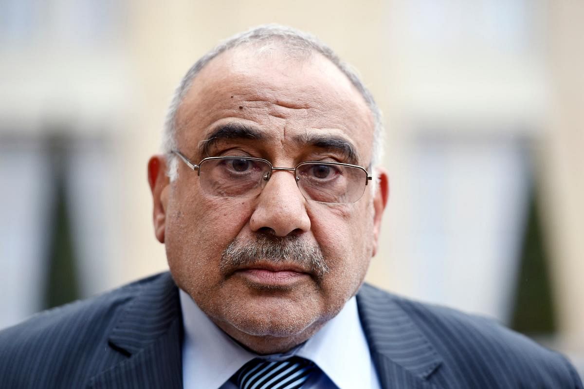 A file photo taken on April 2, 2015 shows then Iraq's oil minister, Adel Abdel Mahdi, listening to questions by the press after a meeting with the French president at the Elysee palace. (AFP Photo)