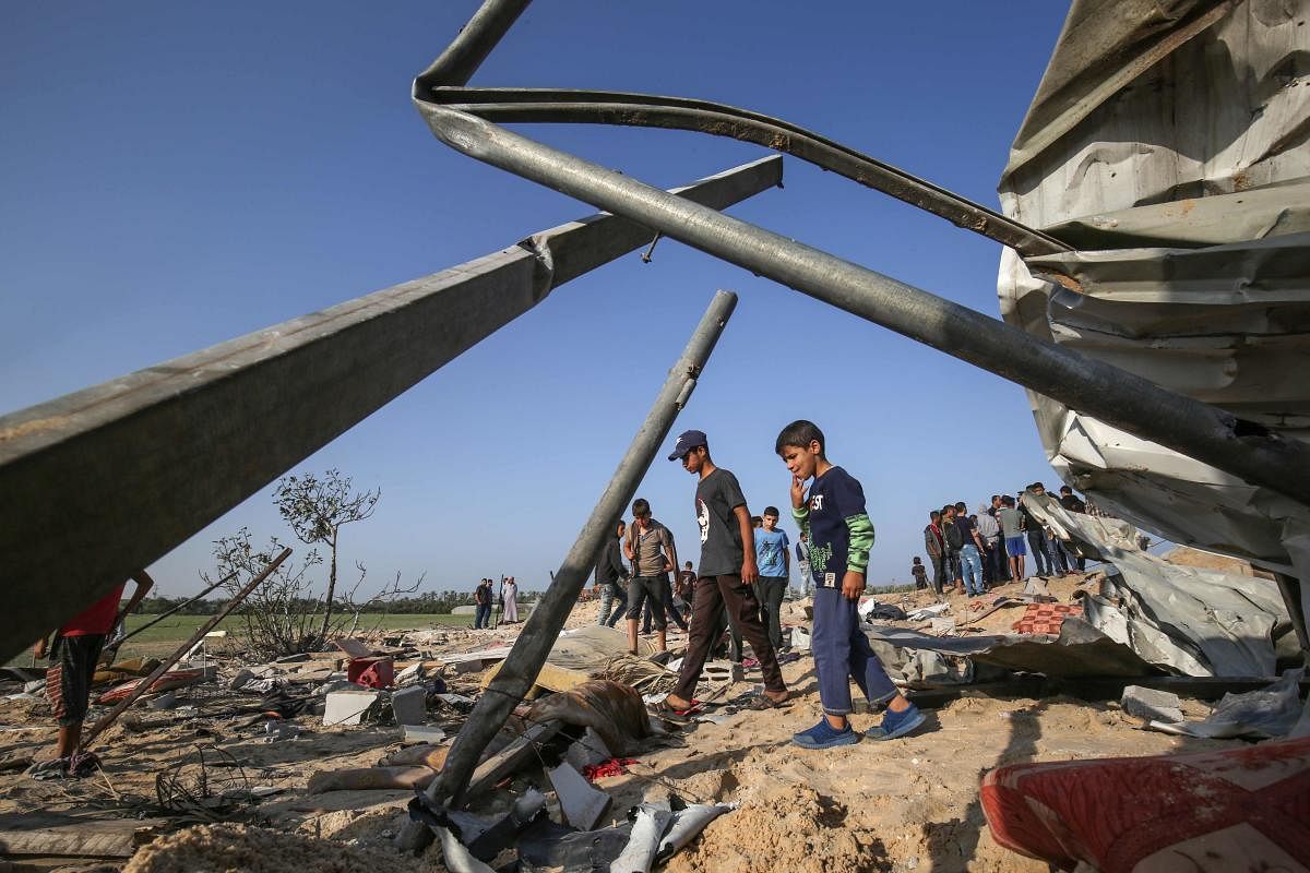 Palestinians gather at the site of an Israeli air strike in Deir al-Balah in the southern Gaza Strip on November 14, 2019. (AFP Photo)