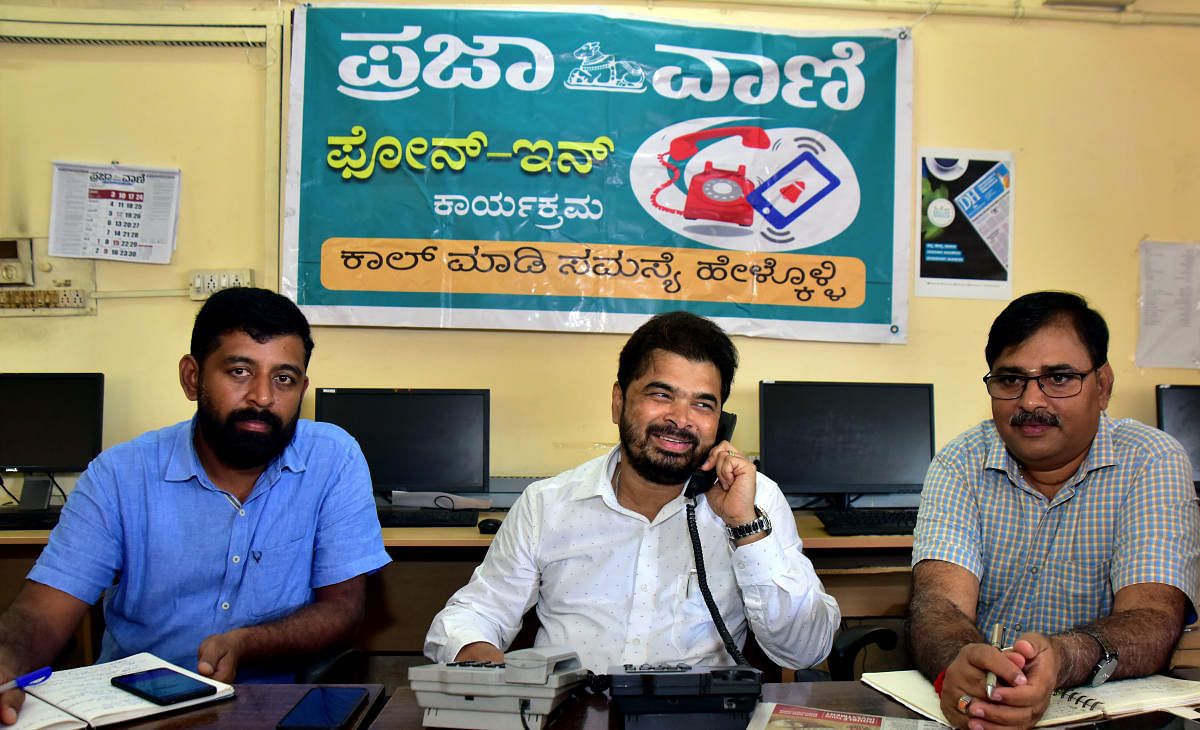 Mangaluru City Corporation Commissioner Ajith Kumar Hegde Shanady receives a call during phone-in programme organised by Prajavani, at DH-PV Editorial Office in Balmatta on Friday. Executive Engineer Linge Gowda and Environmental Engineer Madhu Manohar look on.  DH Photo