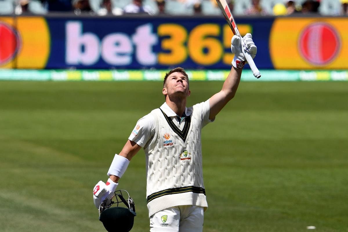 Australia'a batsman David Warner celebrates reaching double century (200 runs) on day two of the second cricket Test match between Australia and Pakistan in Adelaide on November 30, 2019. (AFP Photo)