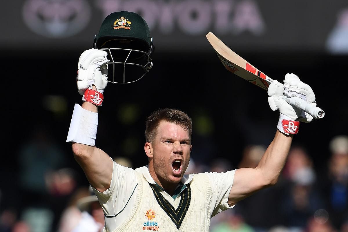 Australia's batsman David Warner celebrates reaching his triple century (300 runs) during day two of the second cricket Test match between Australia and Pakistan in Adelaide on November 30, 2019.AFP