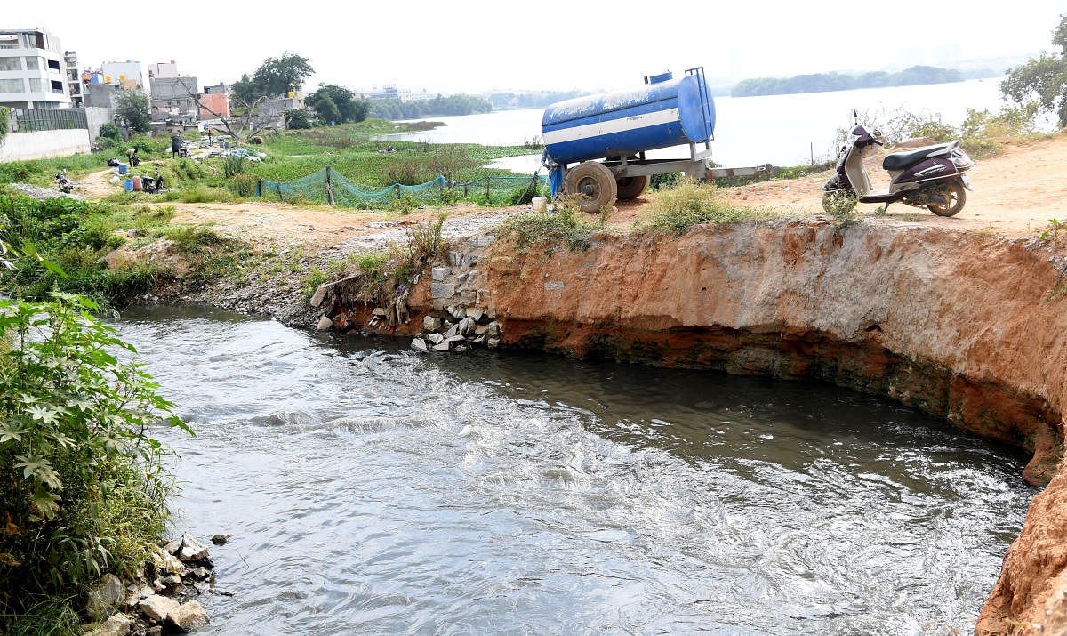 Water from Madivala lake moves through the strome water drain after the water leavel increased due to inflow of the water from Hulimavu lake bleached in Bengaluru. (DH file photo)