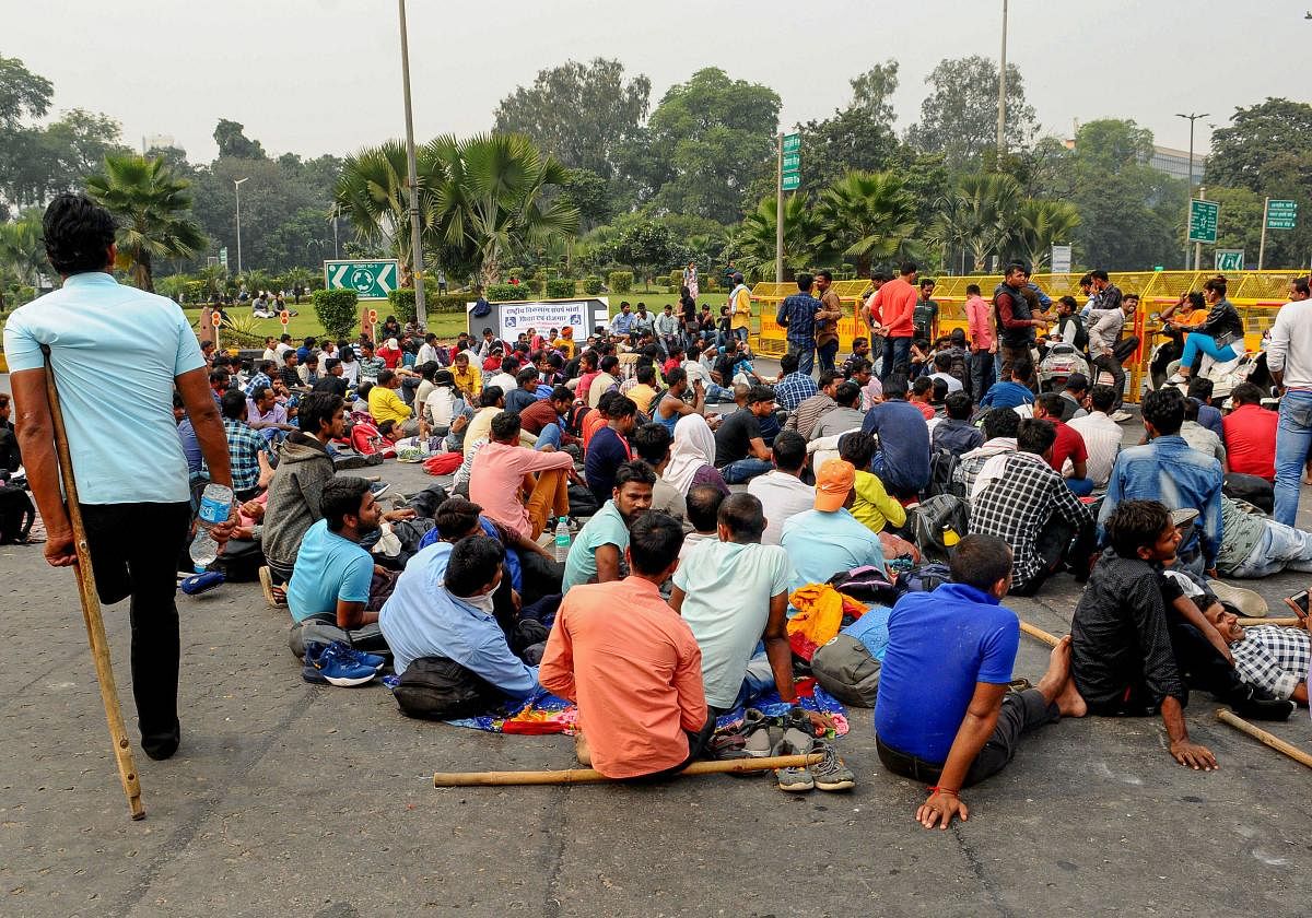 People with disabilities block a road during a protest against the invalidation of railway examination results, near Mandi House in New Delhi, Tuesday, Nov. 26, 2019. (PTI Photo)