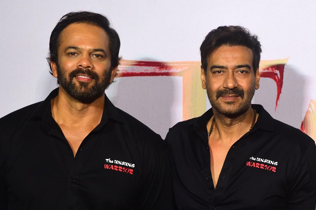 Indian Bollywood director and producer Rohit Shetty (L) and actor Ajay Devgn. (AFP Photo)