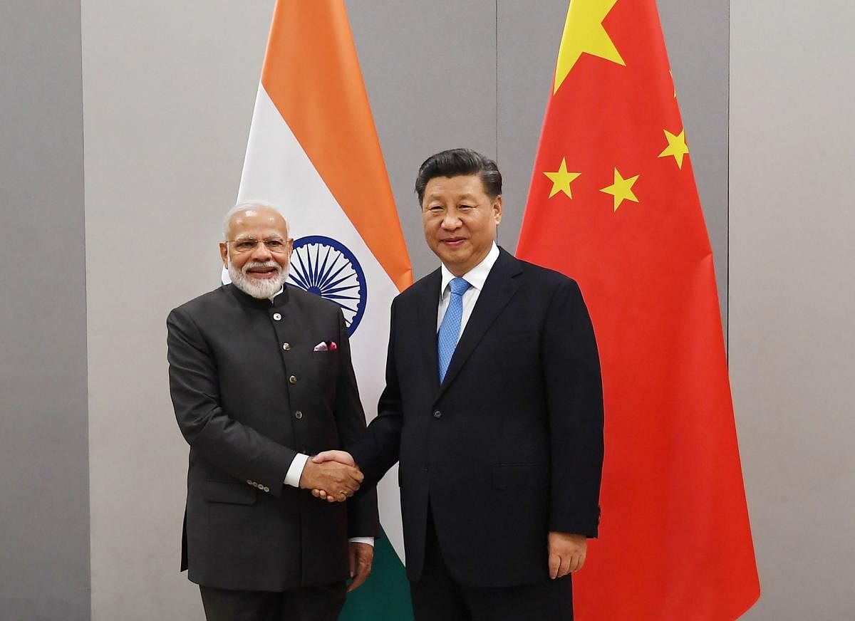 Prime Minister Narendra Modi shakes hands with Chinese President Xi Jinping during a meeting on the sidelines of BRICS Summit, in Brasilia, Brazil, Wednesday, Nov. 13, 2019. (PTI Photo)