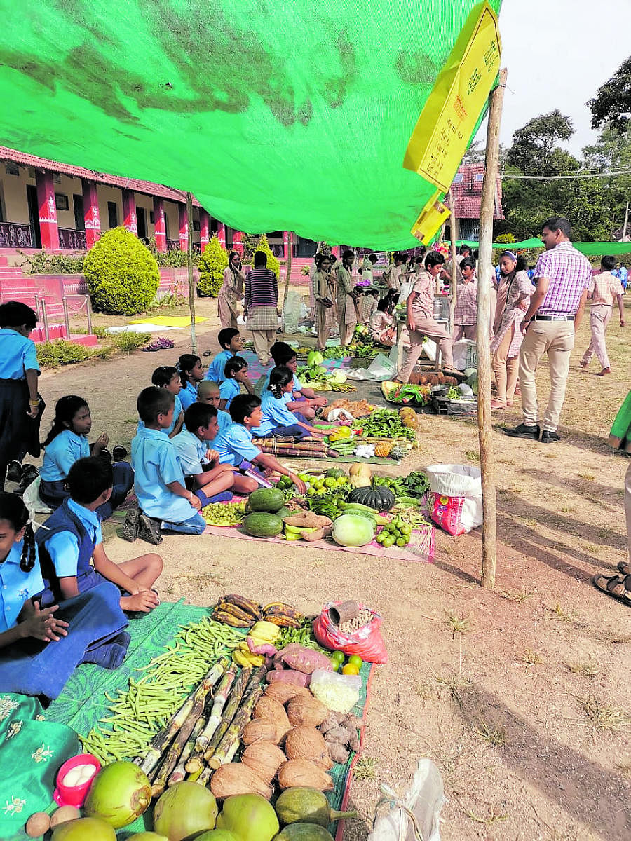 Students of the Government High School in Ankanahalli near Shanivarasanthe sell vegetables during ‘Makkala Santhe’.