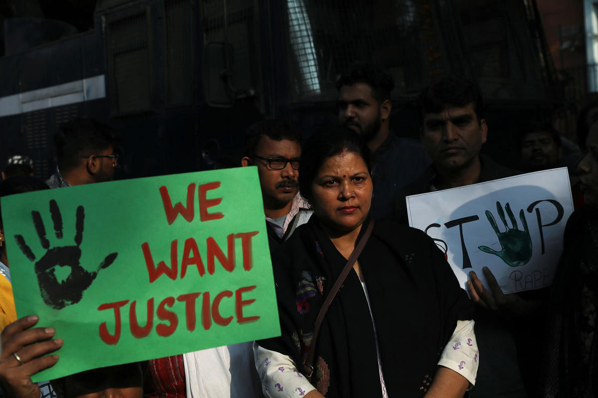 People hold placards and shout slogans as they take part in a protest against the alleged rape and murder of a 27-year-old woman on the outskirts of Hyderabad, in New Delhi, India, November 30, 2019. (Reuters photo)