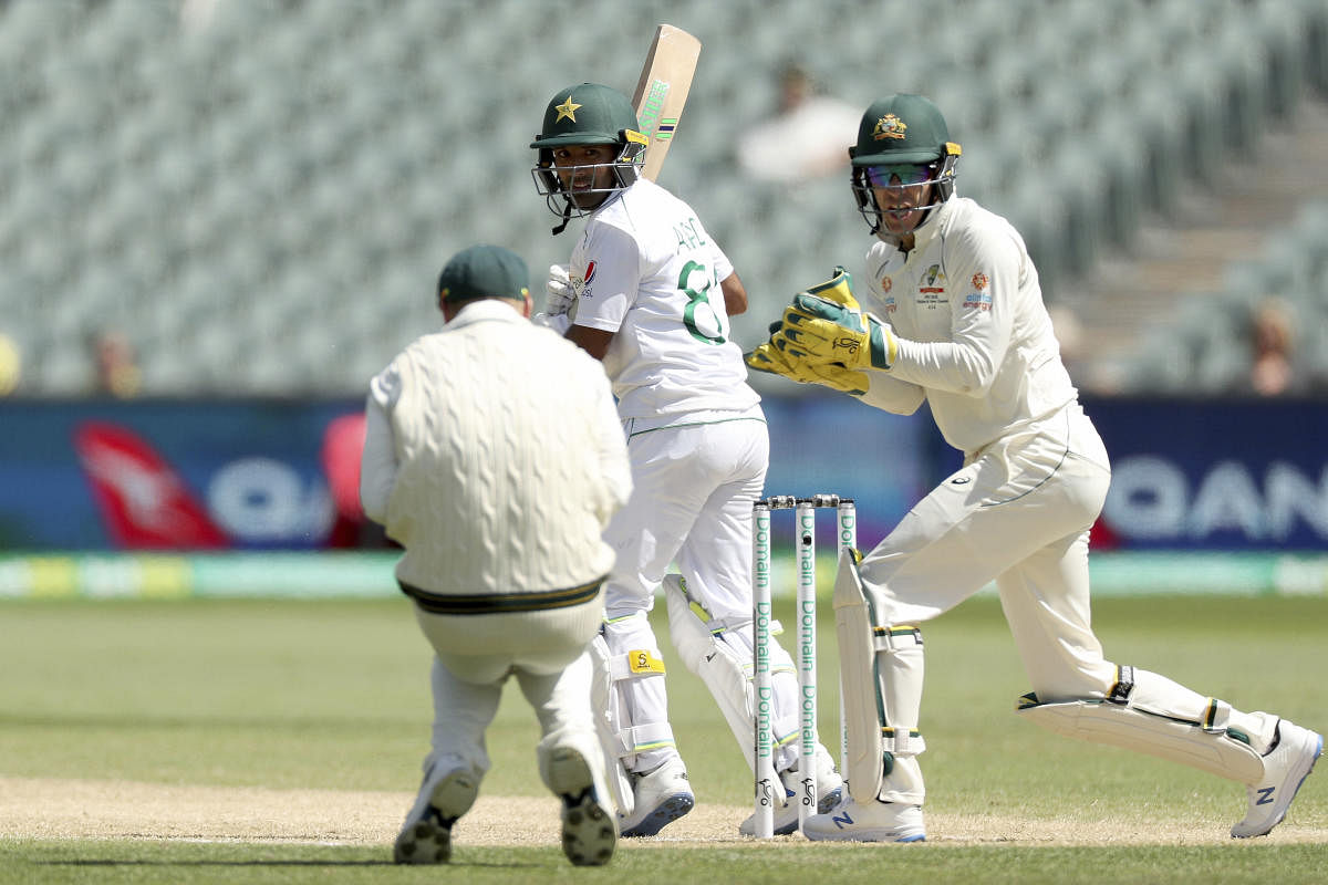 Australia's David Warner, left, catches Pakistan's Asad Shafiq (AP Photo)