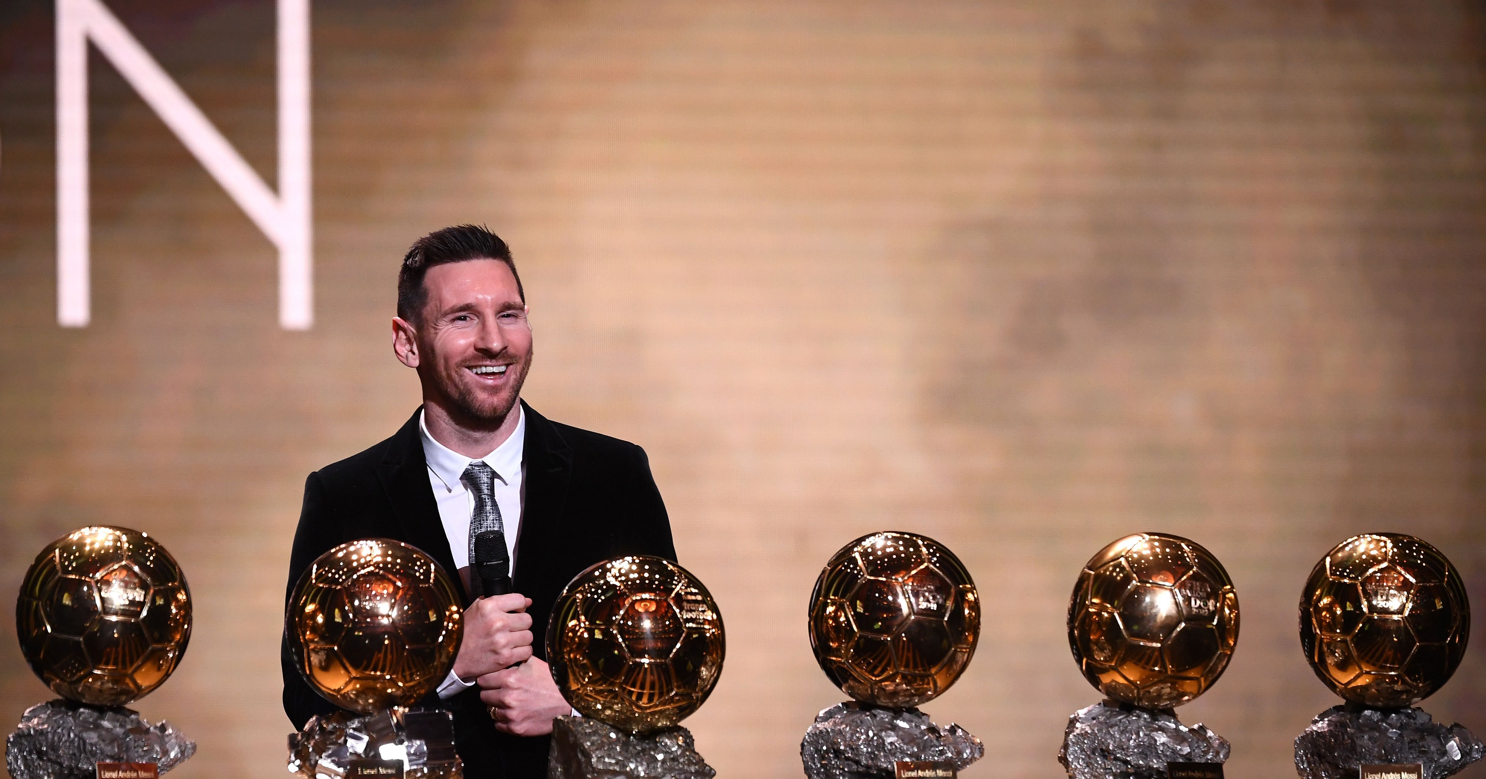 Barcelona's Argentinian forward Lionel Messi reacts after winning the Ballon d'Or France Football 2019 trophy at the Chatelet Theatre in Paris. (AFP Photo)