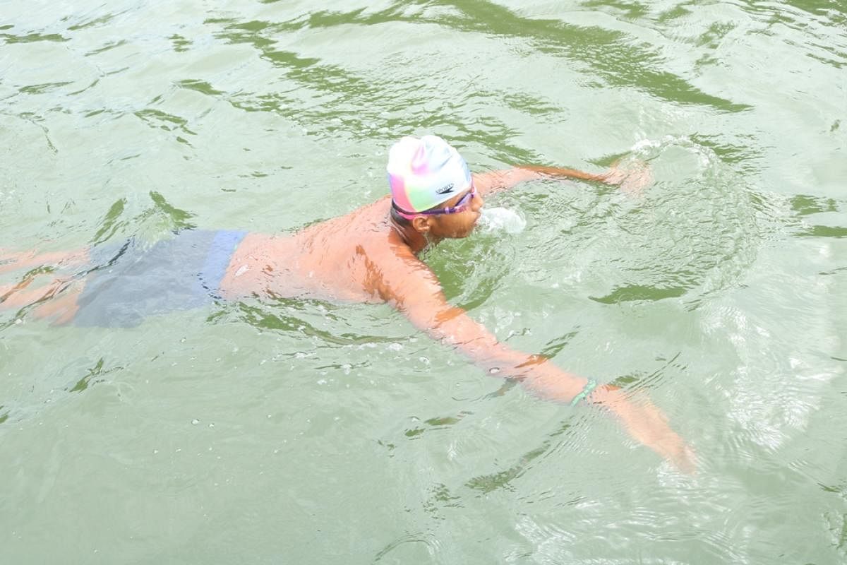 Sampath Kharvi swims in Panchagangavali river at Basroor.