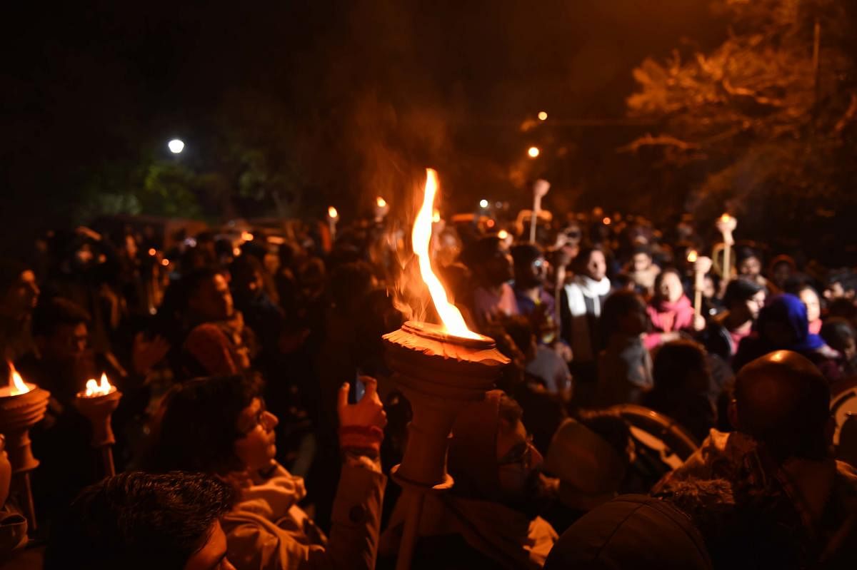 JNU students take part in a Mashal Juloos (torch light procession) to protest against the proposed fee hike and IHA mannual, on the University campus in New Delhi, Tuesday, Dec. 3, 2019. (PTI Photo/Atul Yadav)