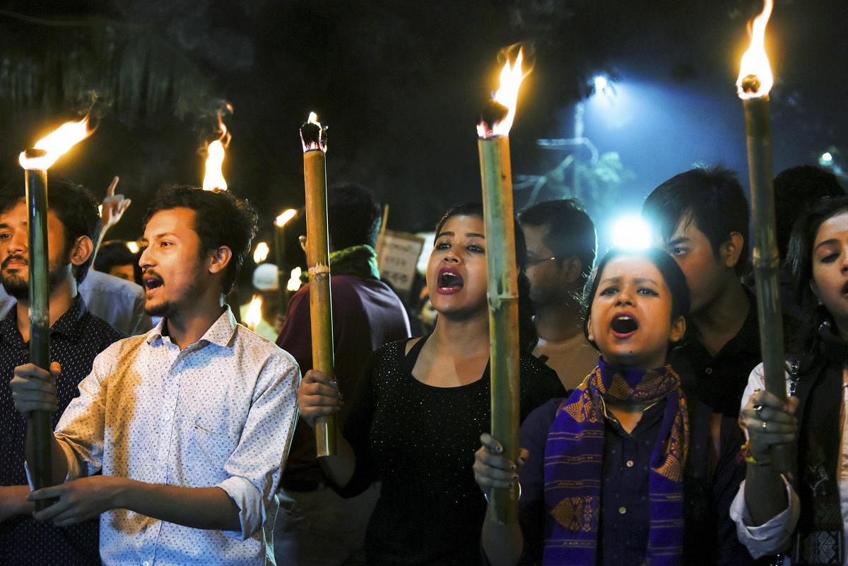 Students of Cotton University along with others participate in a torch rally in protest against the Citizenship Amendment Bill (CAB), in Guwahati, Saturday, Nov. 30, 2019. (PTI Photo)
