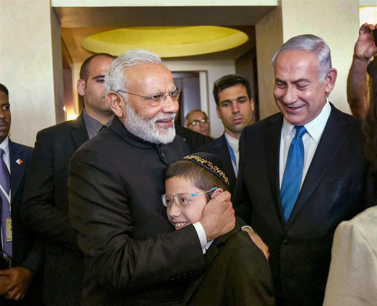 Prime Minister Narendra Modi hugs 13-year-old Moshe Holtzberg, one of the survivors of the 26/11 Mumbai terror attacks, in Jerusalem, Israel. Holtzberg celebrated his bar mitzvah, a Jewish coming of age ritual for boys. Photo/PTI